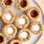 Top view of chocolate chip cookie cups filled with chocolate and milk.