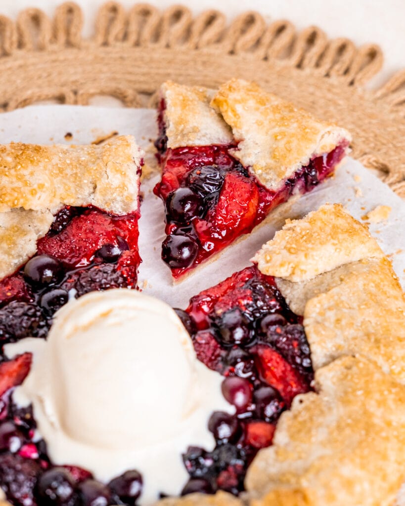 Mixed Berry Galette with a scoop of vanilla ice cream and a triangle slice cut out