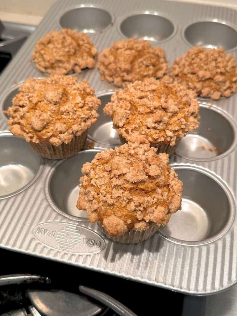 Pumpkin spice coffee cake baked into muffins.
