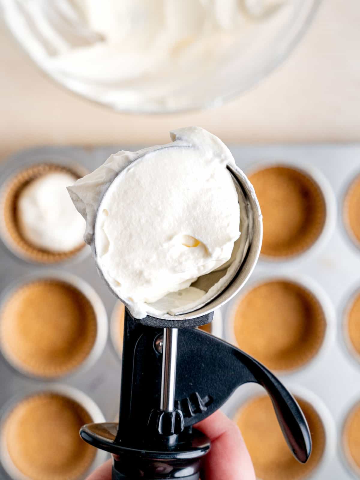 An ice cream scoop filled with no bake cheesecake filling.