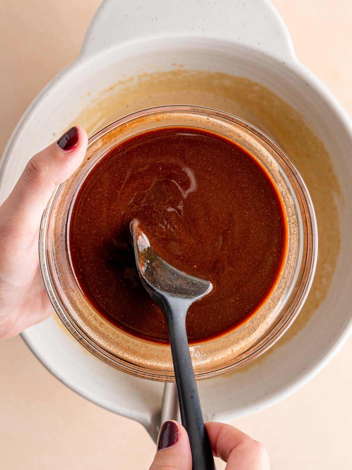 Stirring melted chocolate and butter in a bowl.