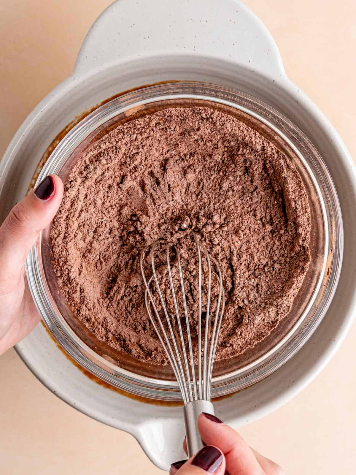 Whisking together flour, cocoa powder, and salt in a bowl.