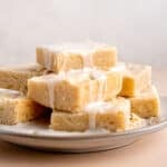 A plate of lemon sugar cookie bars with lemon icing.