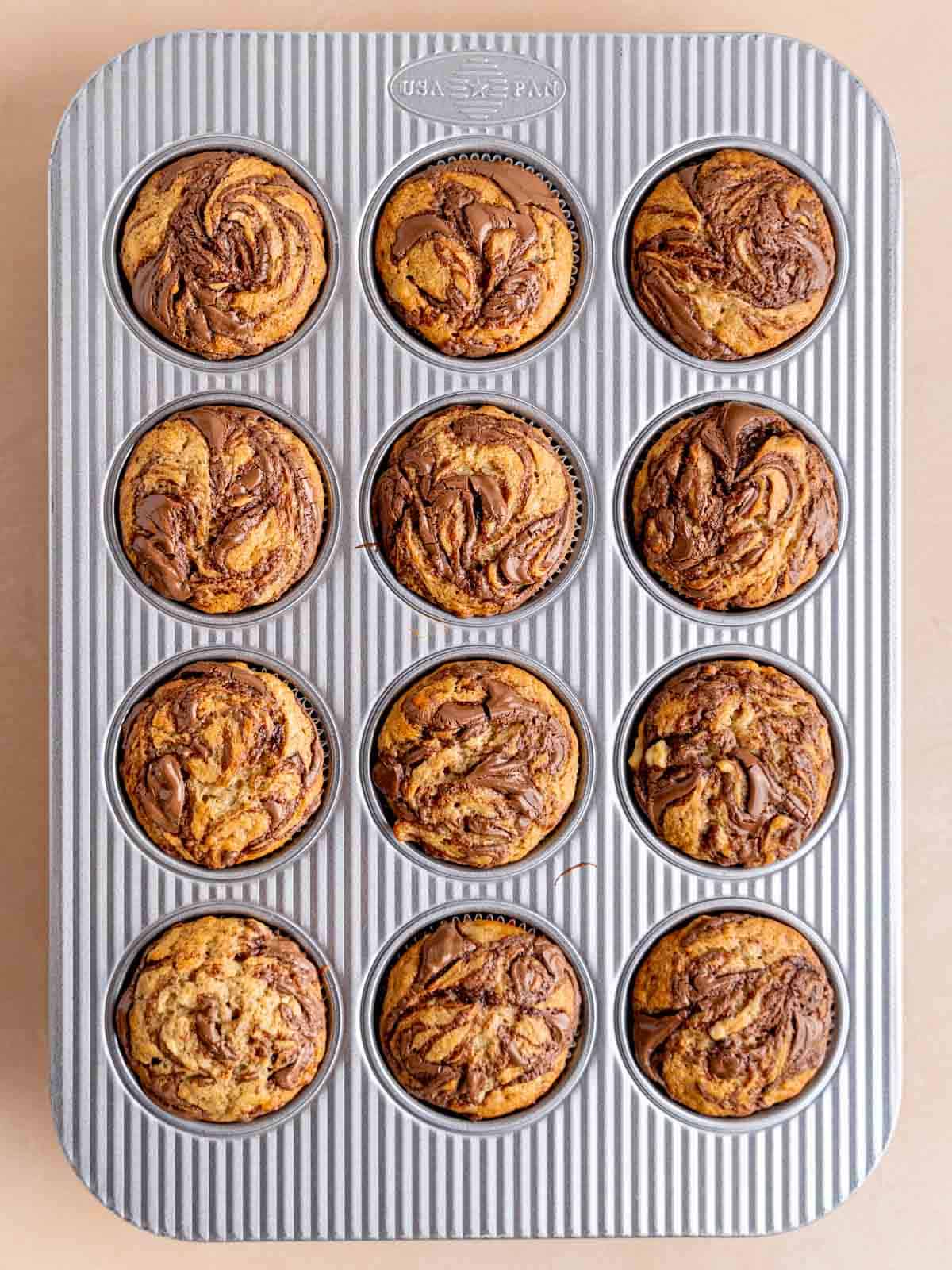 Banana Nutella muffins baked in a muffin pan.