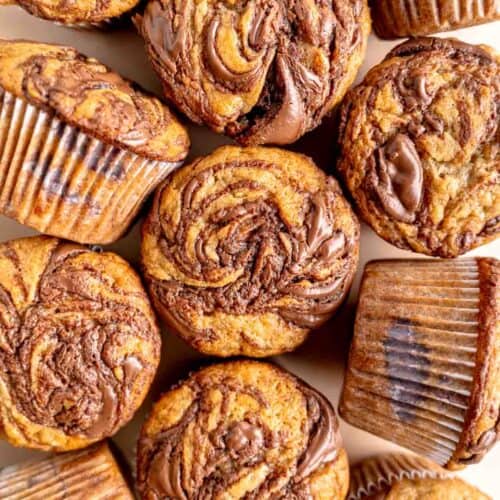 Banana muffins with Nutella swirled on top and in the middle.