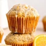 A stack of orange poppy seed muffins with glaze.