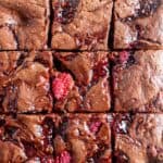 Top view of chocolate raspberry brownies cut into squares.