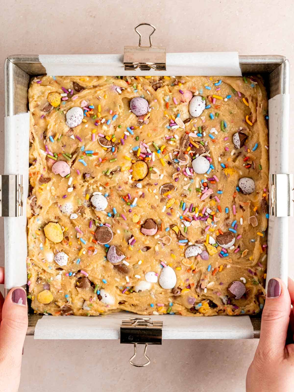 Mini egg blondie batter in an 8x8 inch pan.