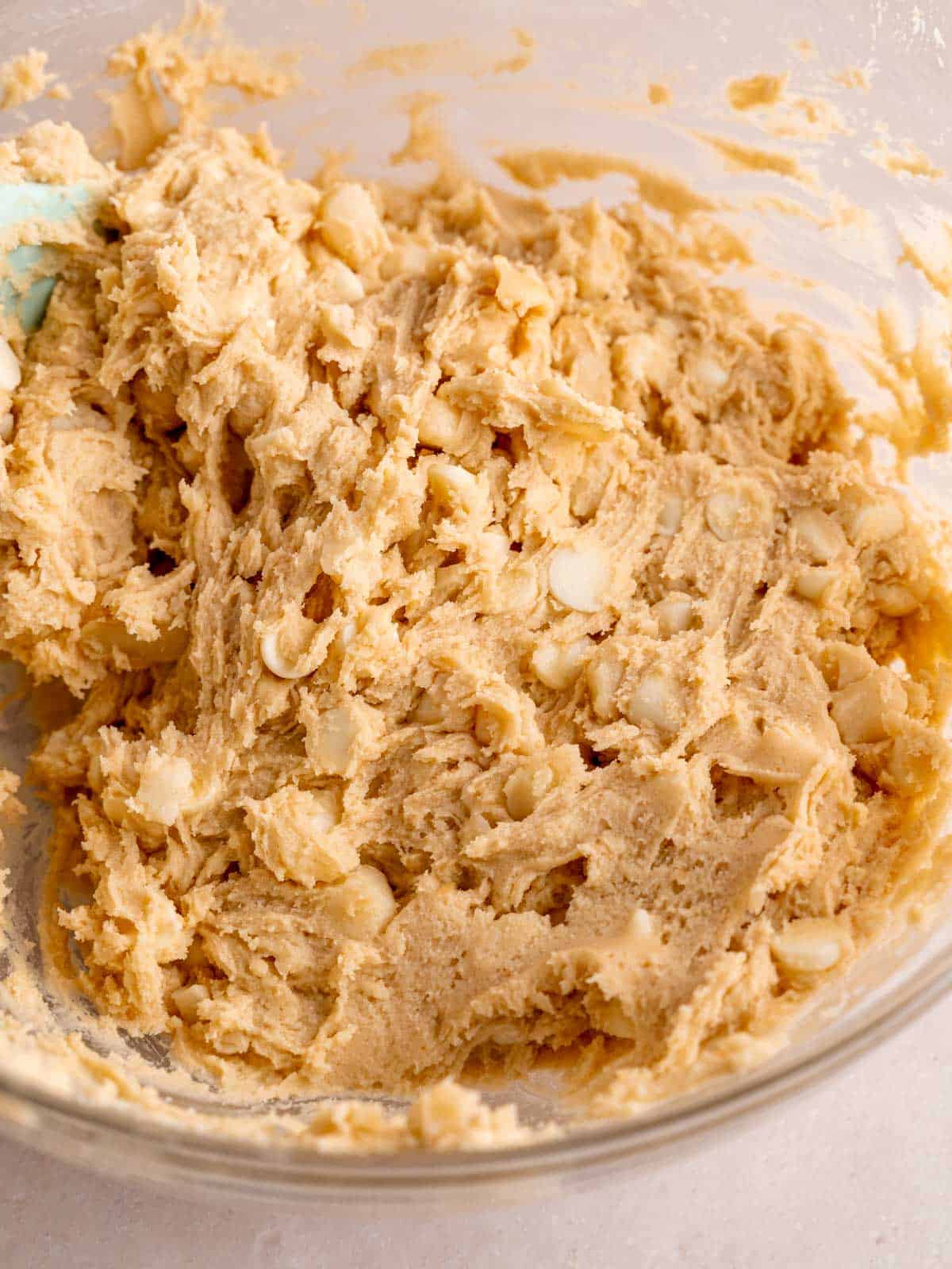 White chocolate chip macadamia nut cookie dough in a bowl.