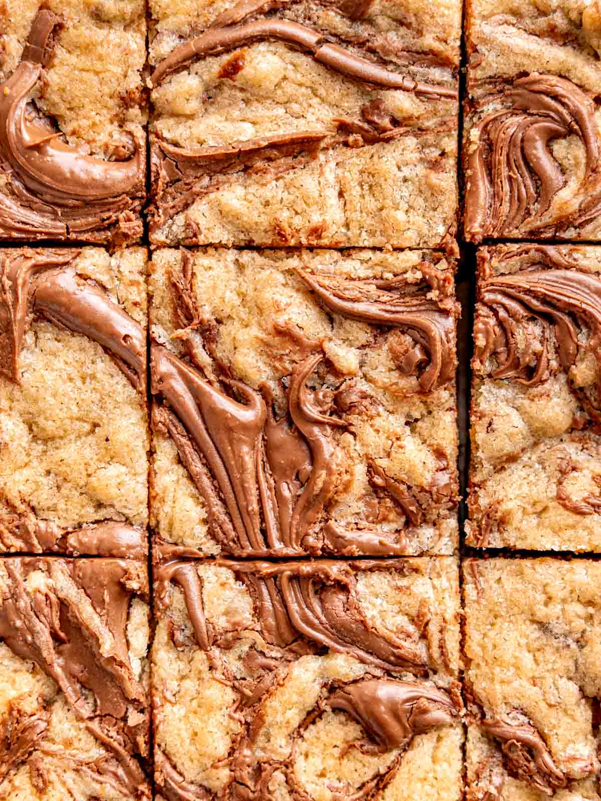 A top view of swirled Nutella cookie bars cut into squares.