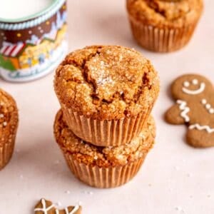 A stack of bakery-style gingerbread muffins with coarse sugar on top.