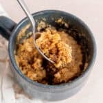 A bite of banana bread mug cake on a spoon.