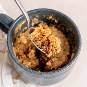 A bite of banana bread mug cake on a spoon.