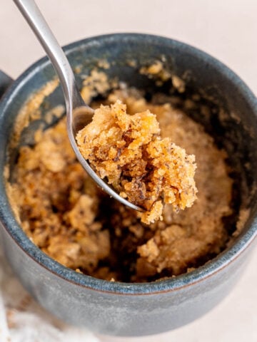 A bite of banana bread mug cake on a spoon.