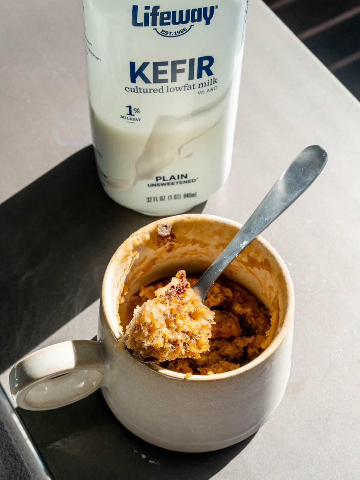 Banana bread mug cake next to a bottle of Lifeway Kefir.