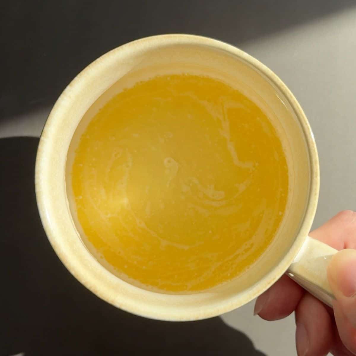 Melted butter in a coffee mug.