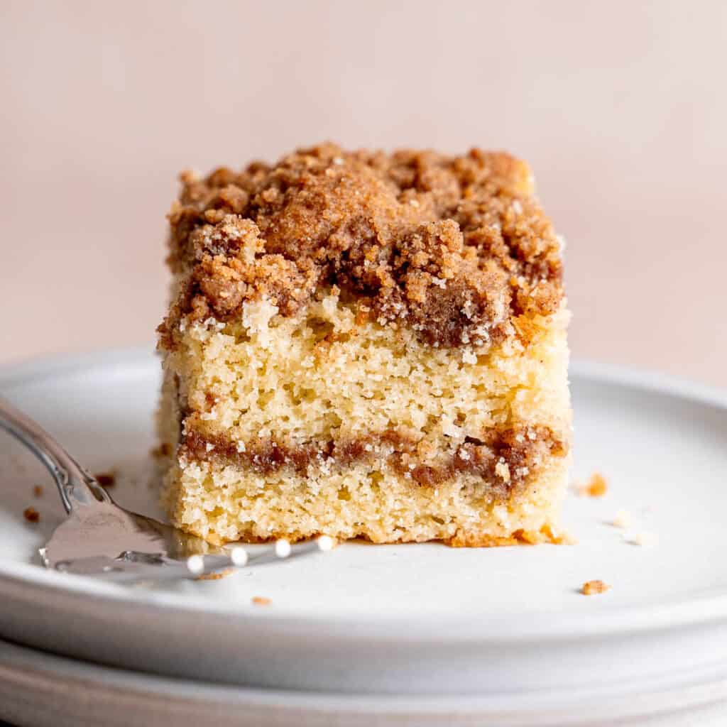 A slice of sourdough discard coffee cake with cinnamon streusel layers.