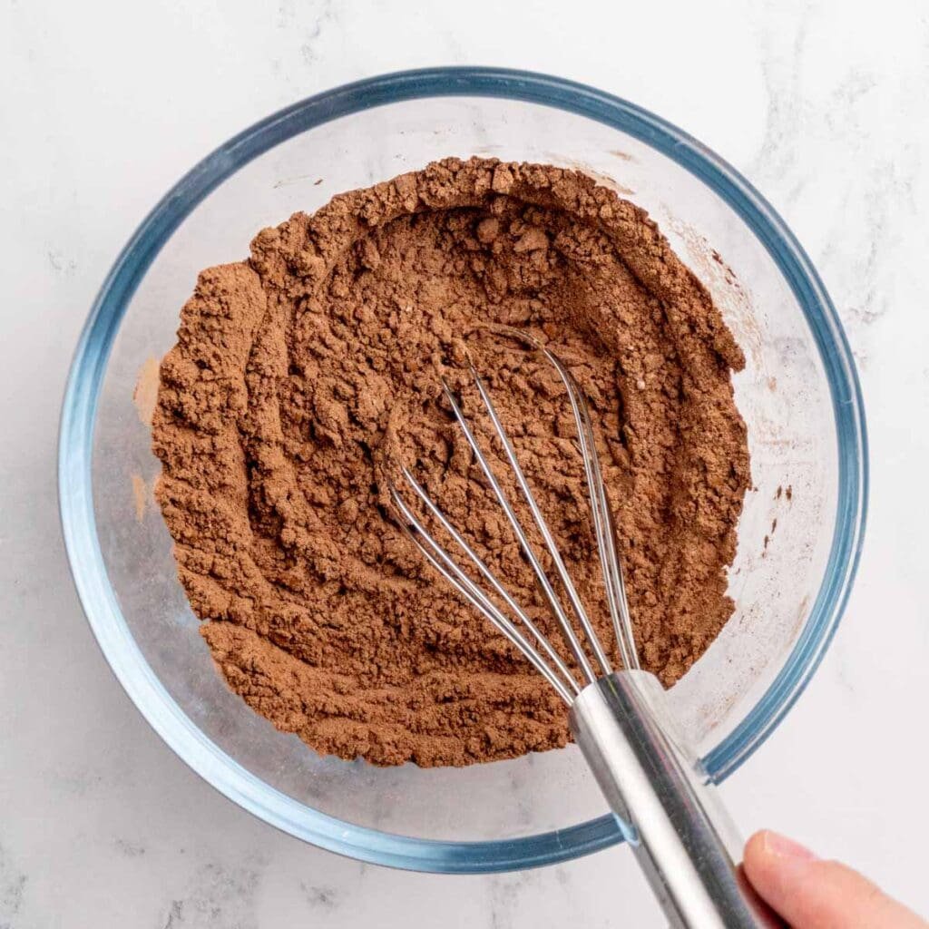 Whisking all-purpose flour, cocoa powder, and salt in a bowl.