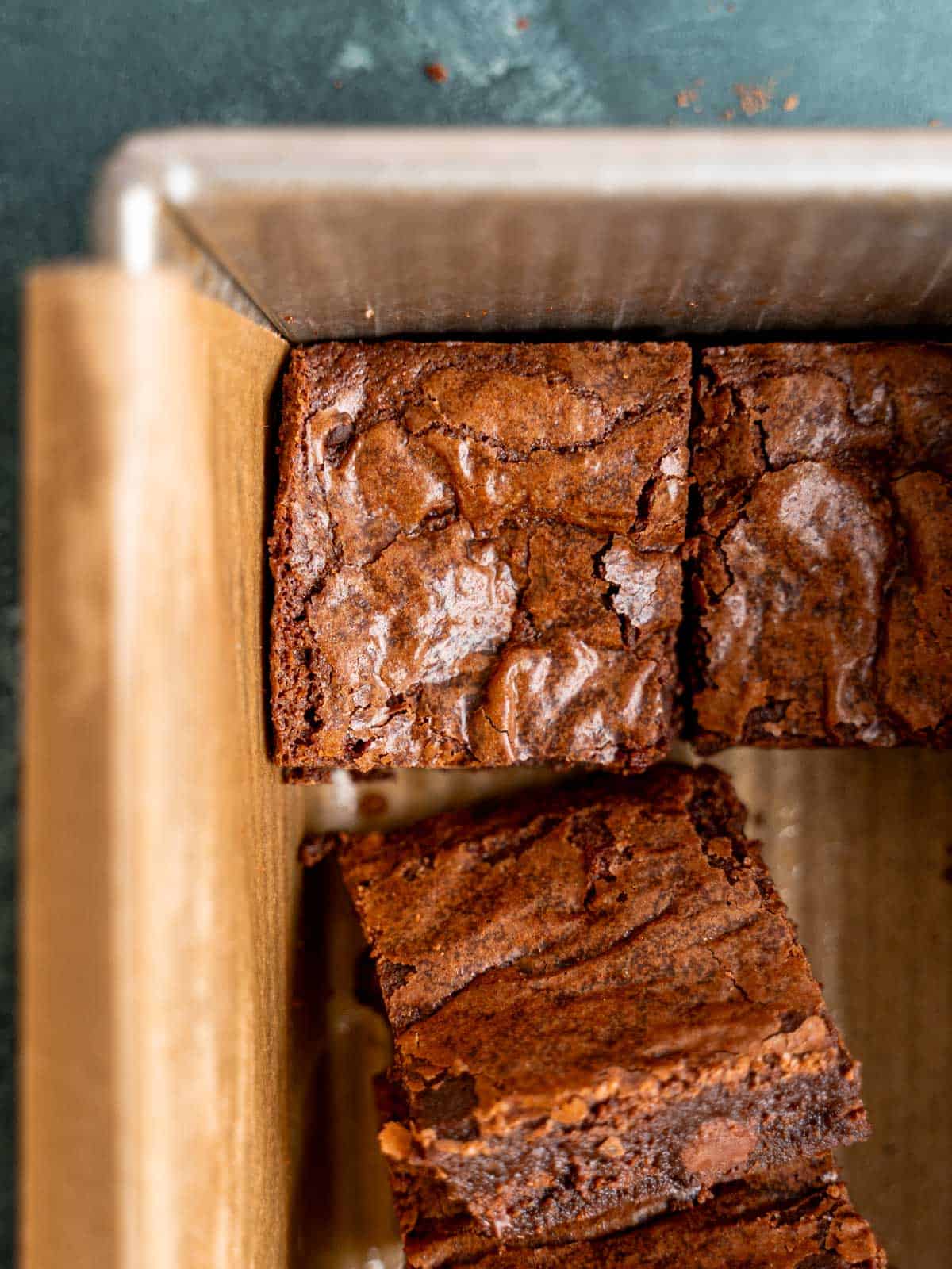 A crinkle-top brownie in a parchment-lined loaf pan.