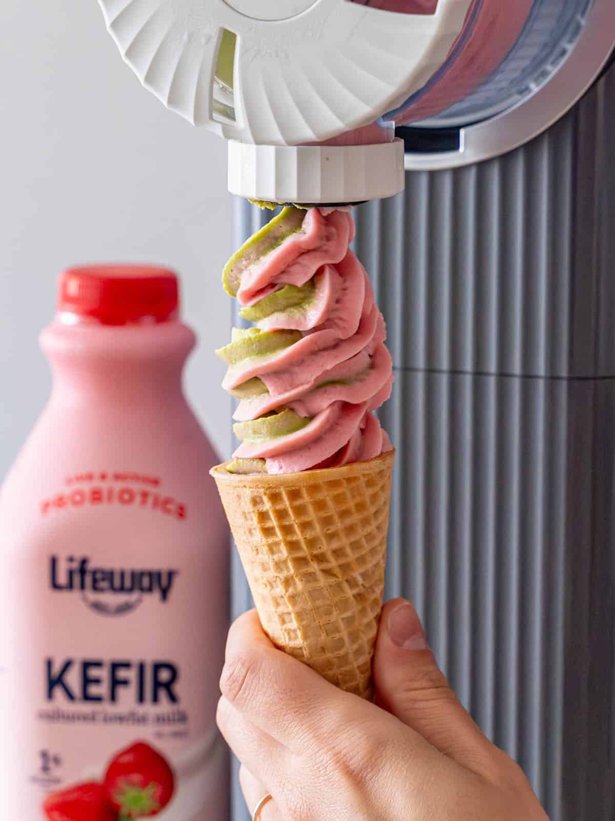 Swirling matcha and strawberry ice cream out of a Ninja Creami Swirl.