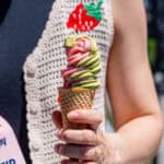 Kayla Burton holding strawberry matcha ice cream in a sugar cone.