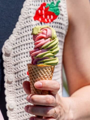 Kayla Burton holding strawberry matcha ice cream in a sugar cone.