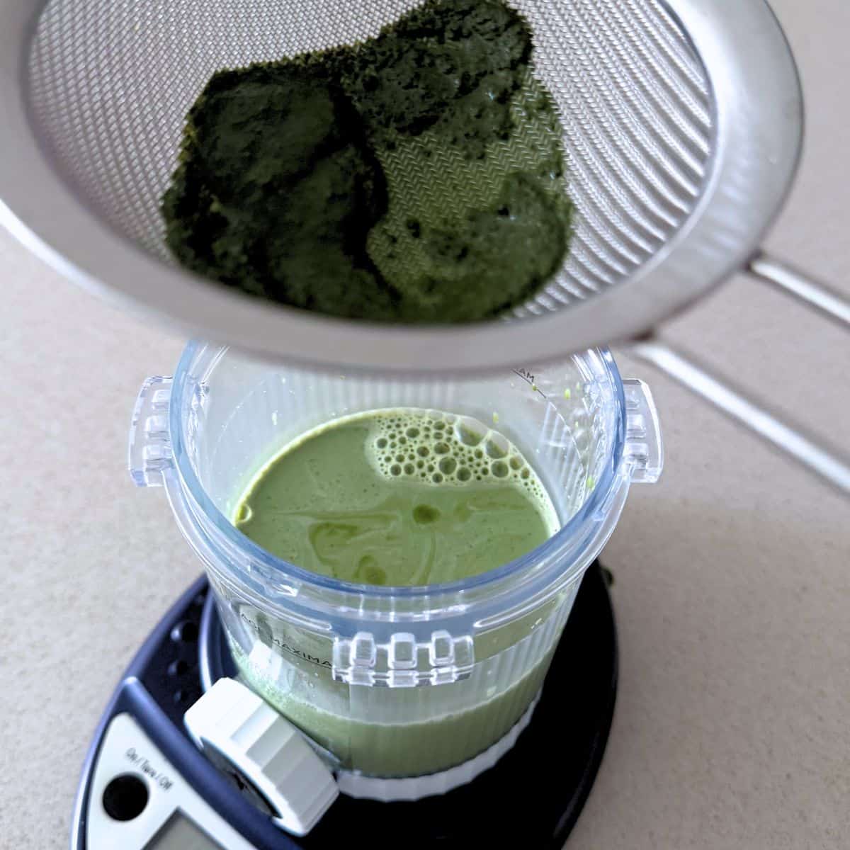 Straining a sweetened matcha milk mixture.