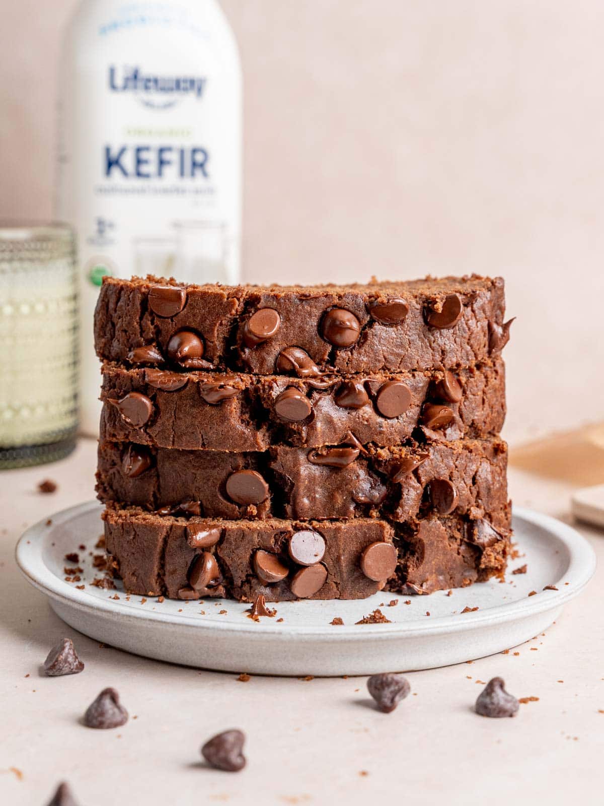 A stack of chocolate loaf cake slices on a plate.