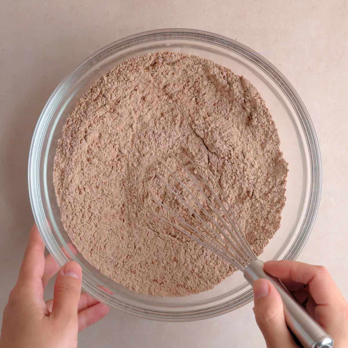 Whisking flour, sugar, cocoa powder, baking powder, and salt in a bowl.