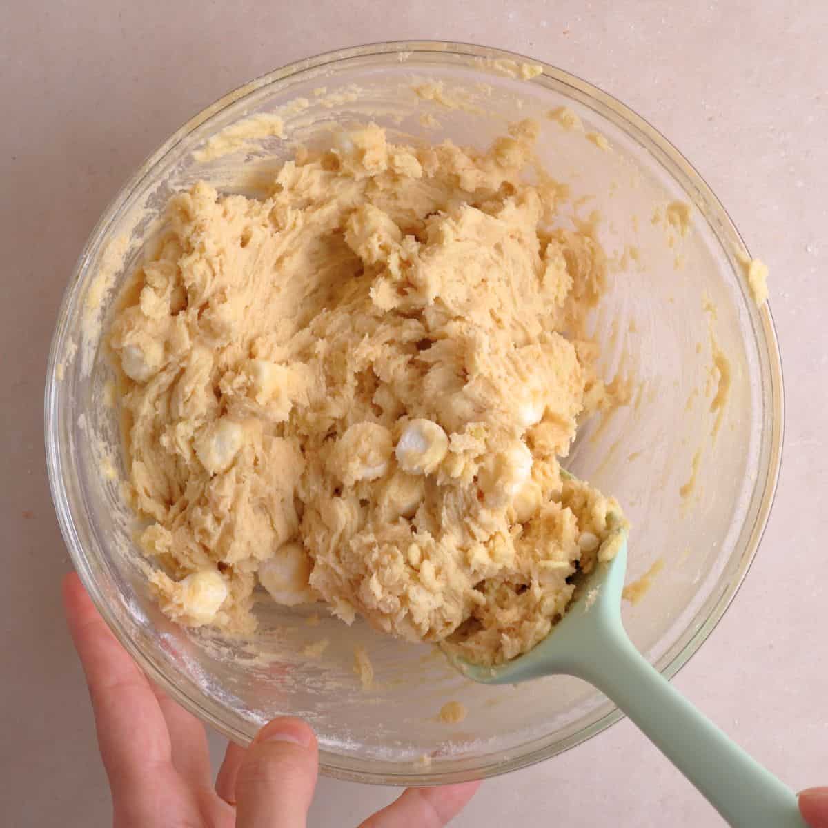 Crispy rice cereal and mini marshmallows mixed into cookie mixture.