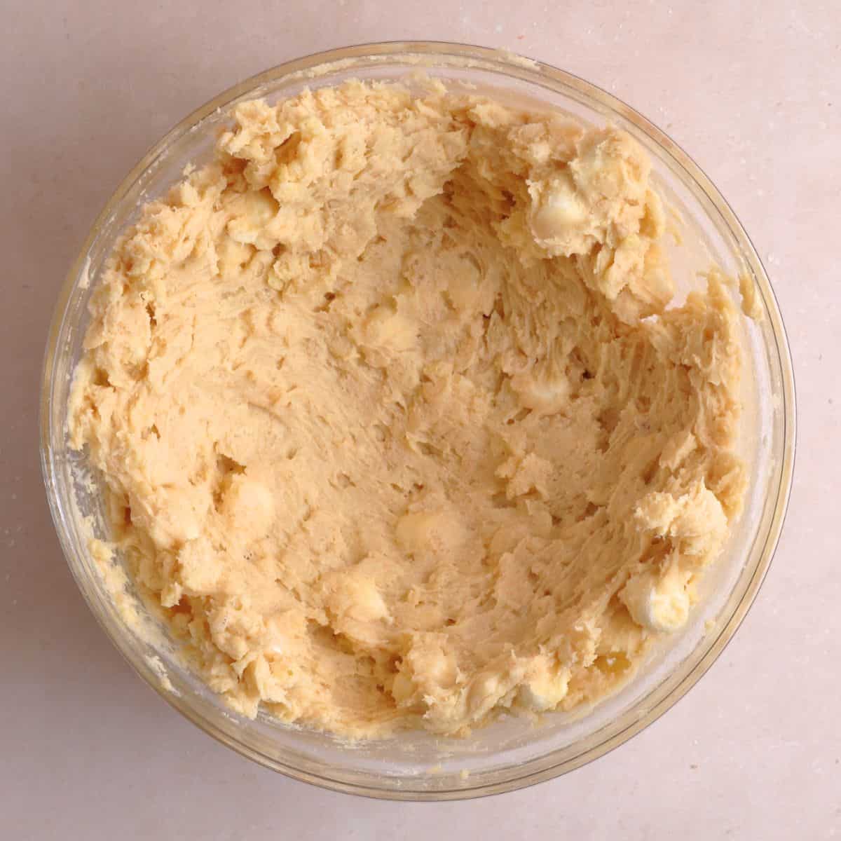 Marshmallow crispy cookie dough pressed against the sides of a bowl.