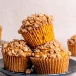 A stack of pumpkin oatmeal muffins on a plate.