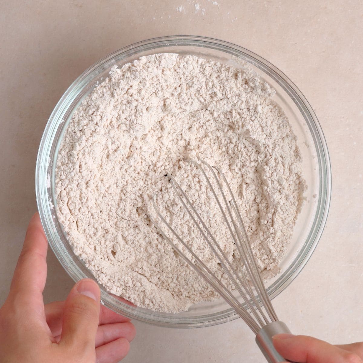 Flour, baking powder, pumpkin pie spice, cinnamon, and salt whisked together in a bowl.