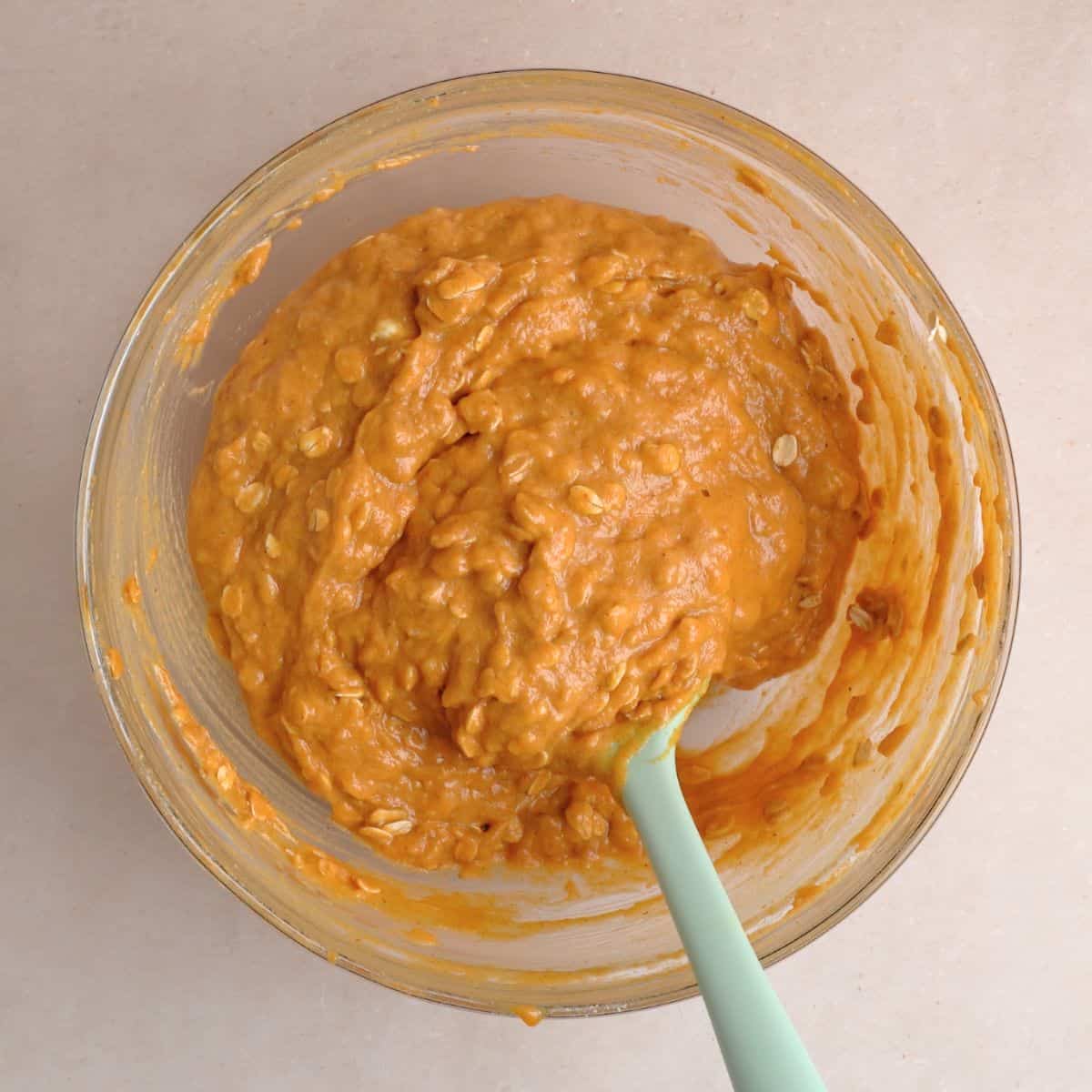 The oats are mixed into the pumpkin muffin batter.