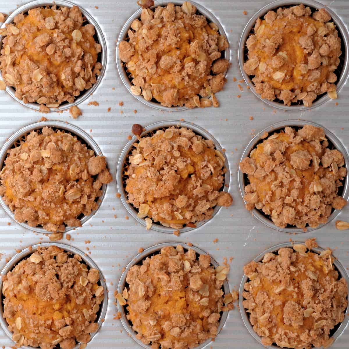 Pumpkin oatmeal muffins with streusel topping after coming out of the oven with golden brown tops.