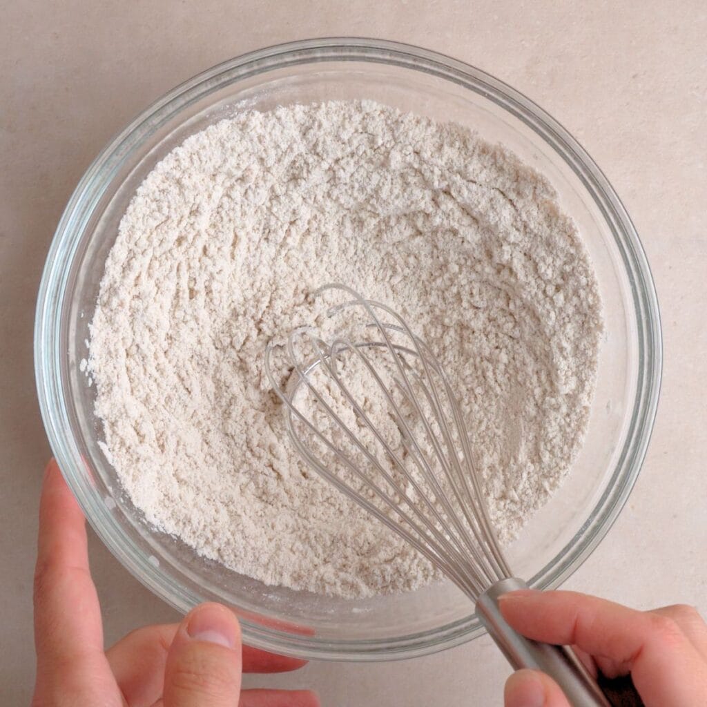 Flour, cinnamon, baking soda, and salt whisked together in a bowl.