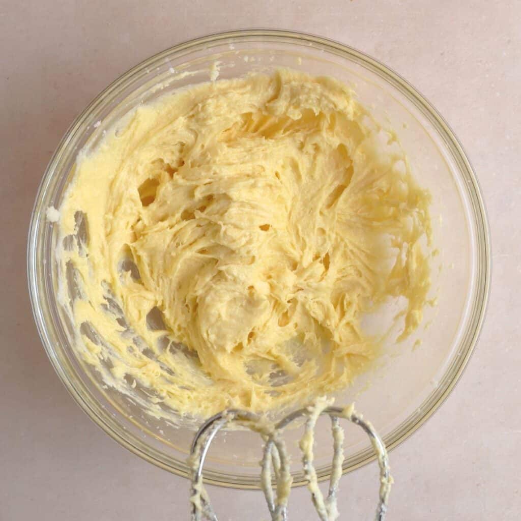 Butter, sugar, sourdough discard, egg yolk, and vanilla extract creamed together in a bowl.