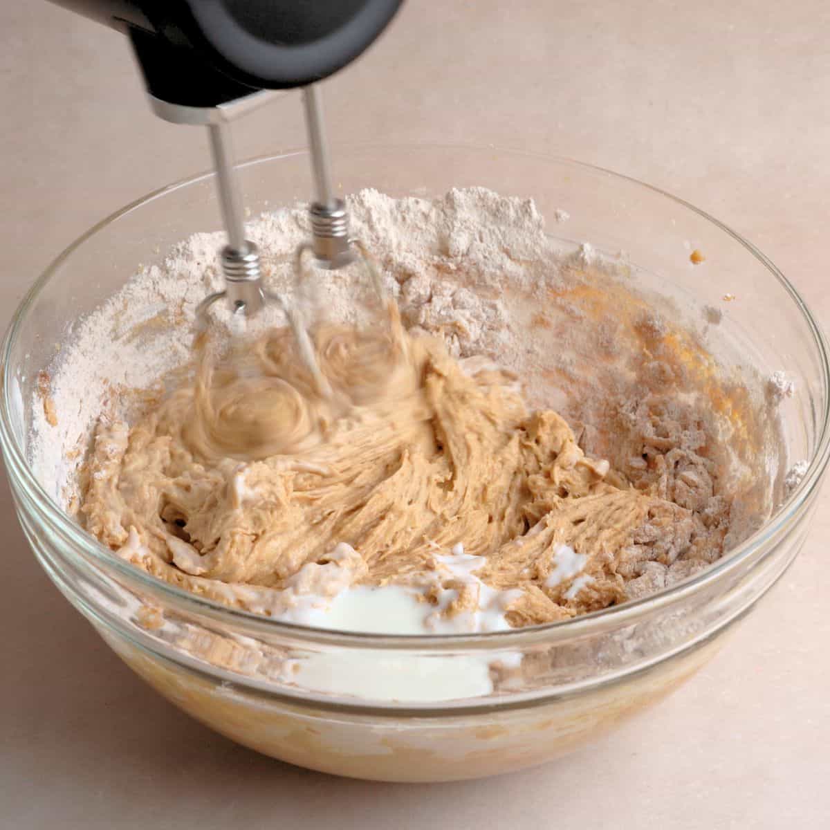 Dry ingredients and kefir mixed into wet ingredients to create spice cake batter.