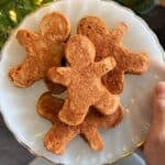 Gingerbread man pancakes on a plate.