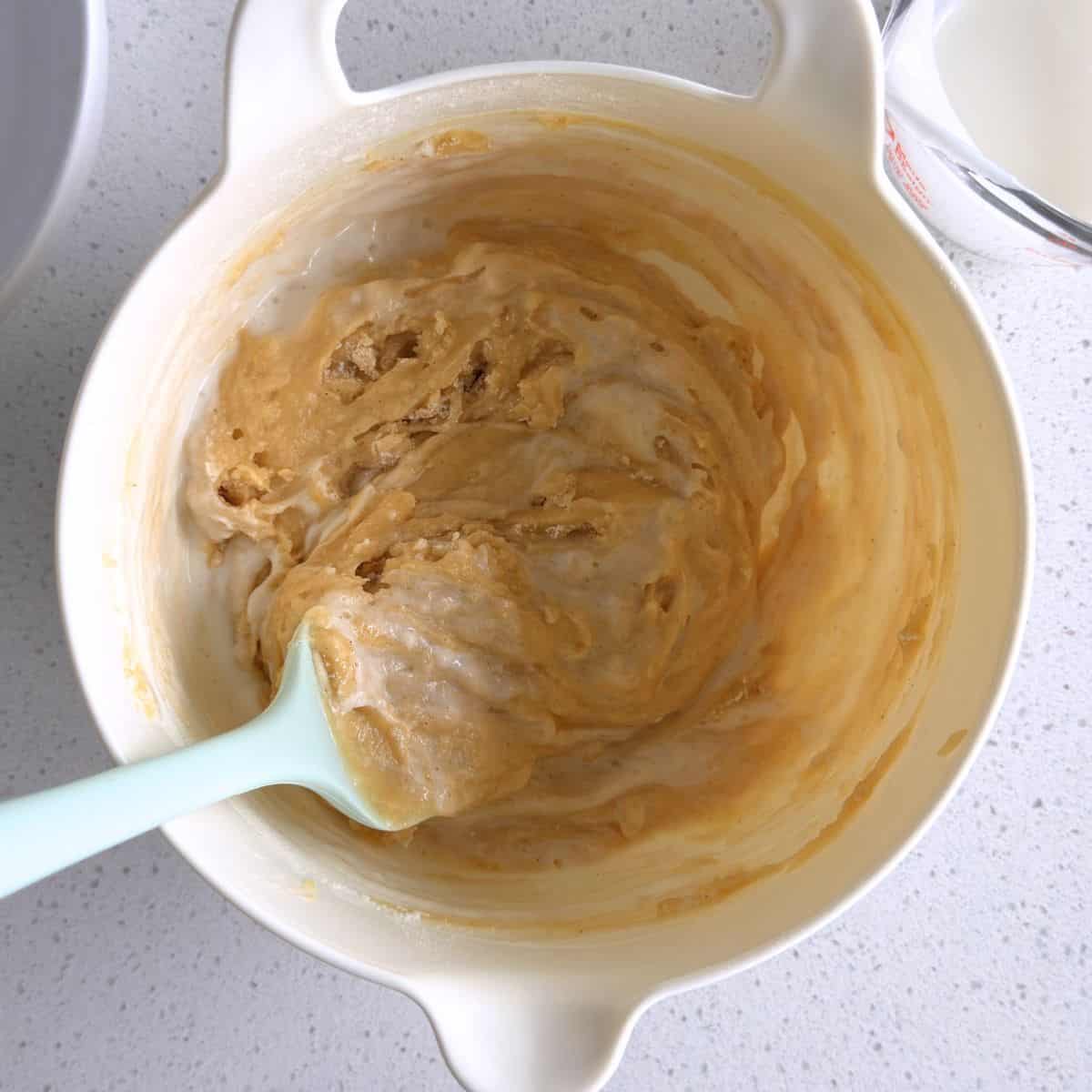 Dry ingredients and kefir mixed into wet ingredients to make honey muffin batter.