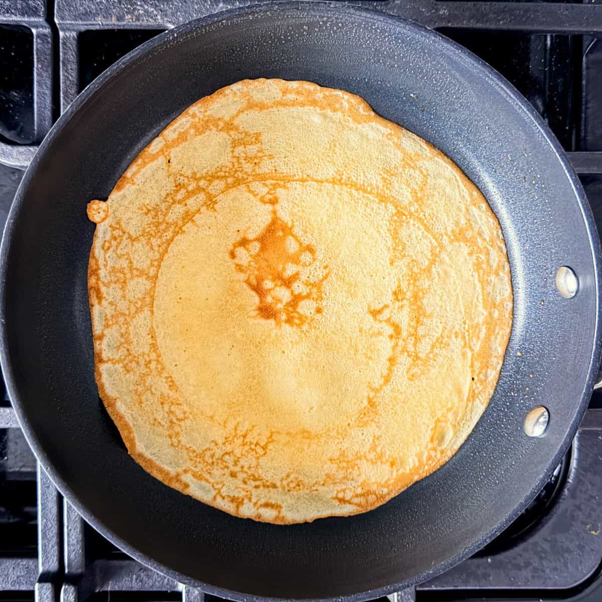 Golden brown crepe on a pan.