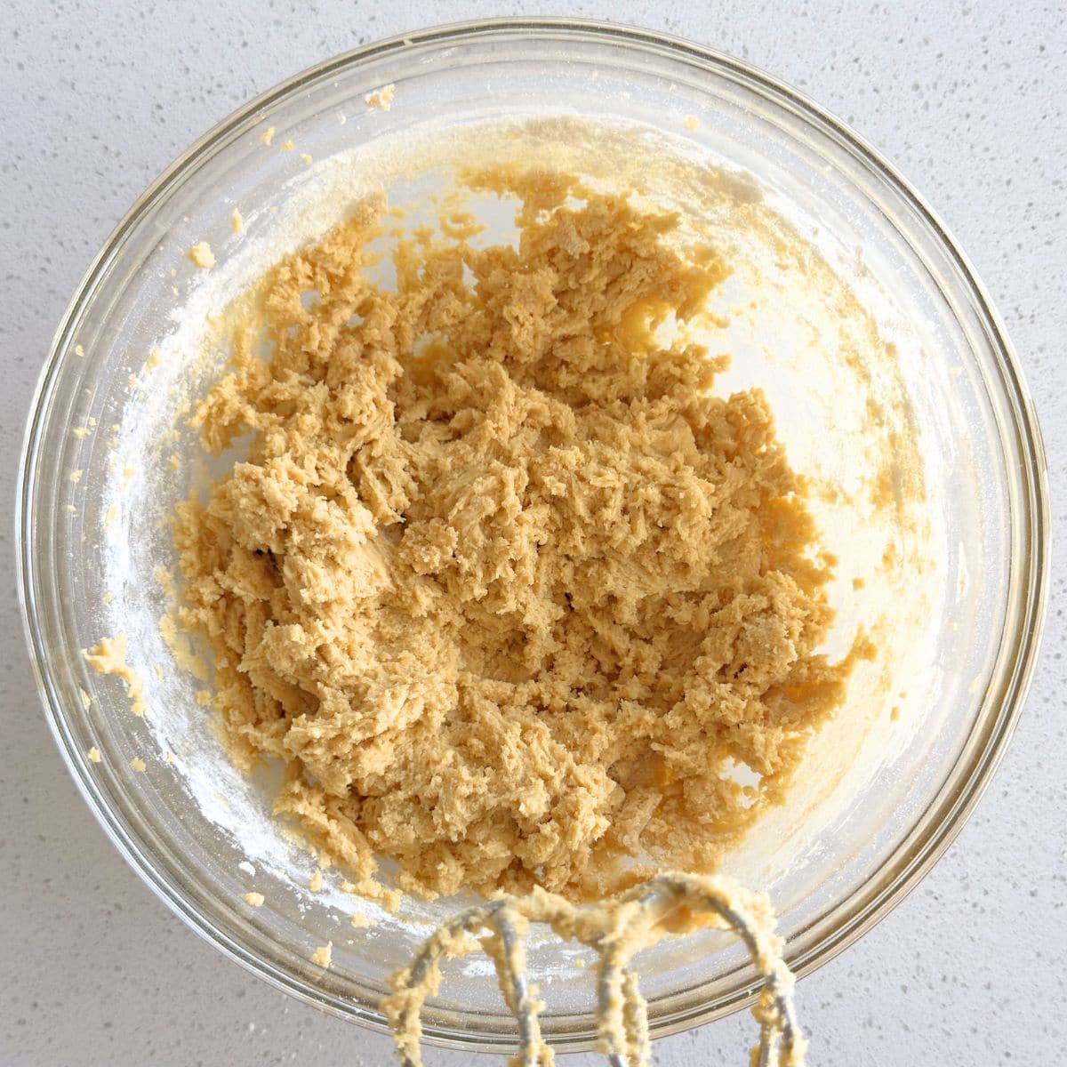 Dry ingredients mixed into wet ingredients to make cookie dough.