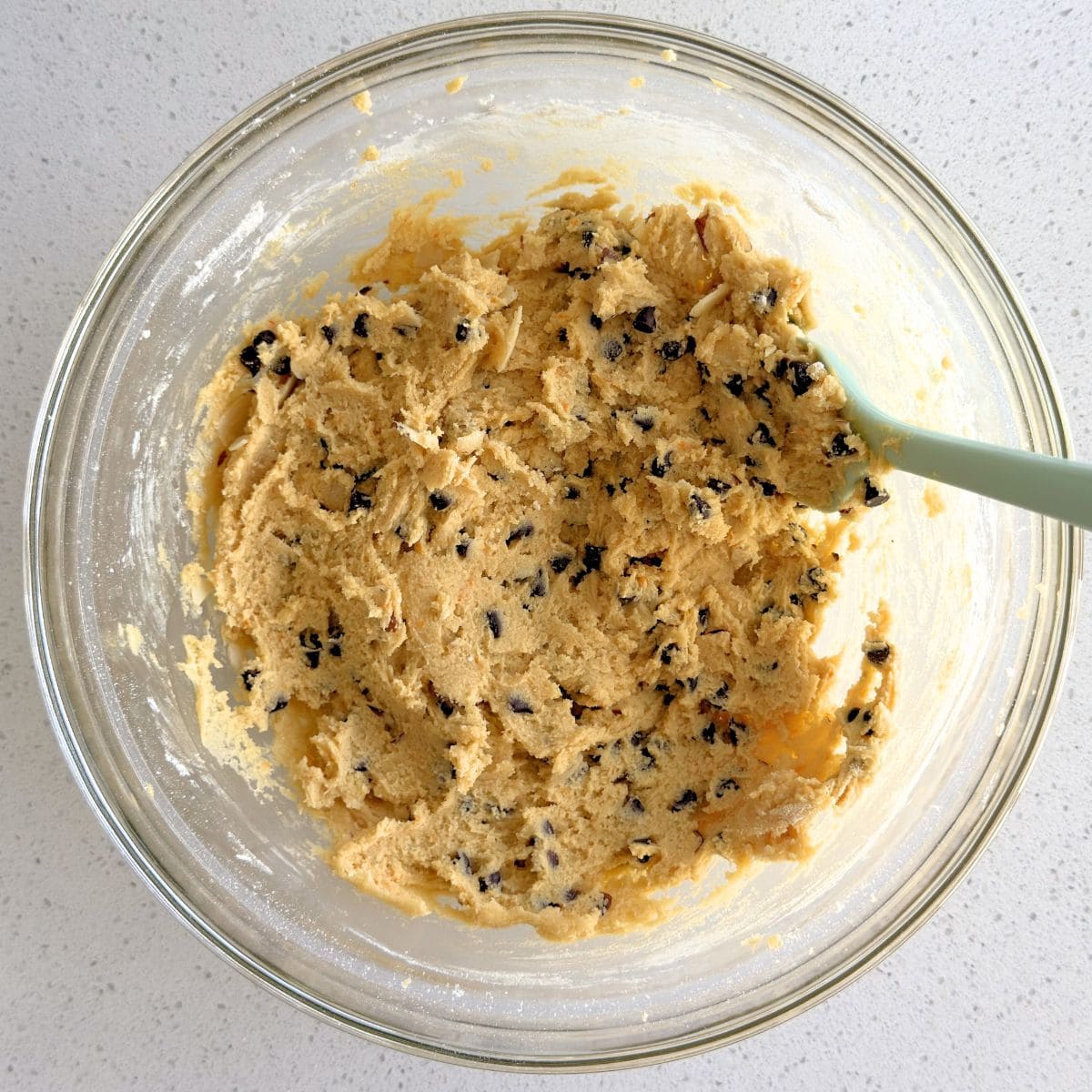 Mini chocolate chips and sliced almonds mixed into cookie dough.