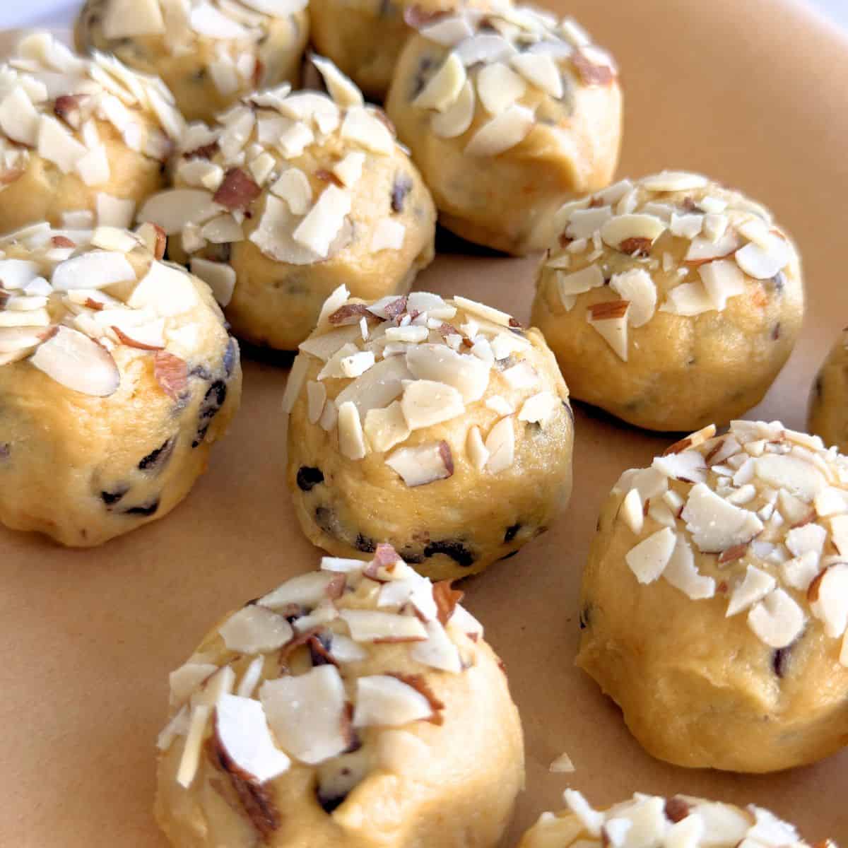 Cookie dough balls topped with sliced almonds.