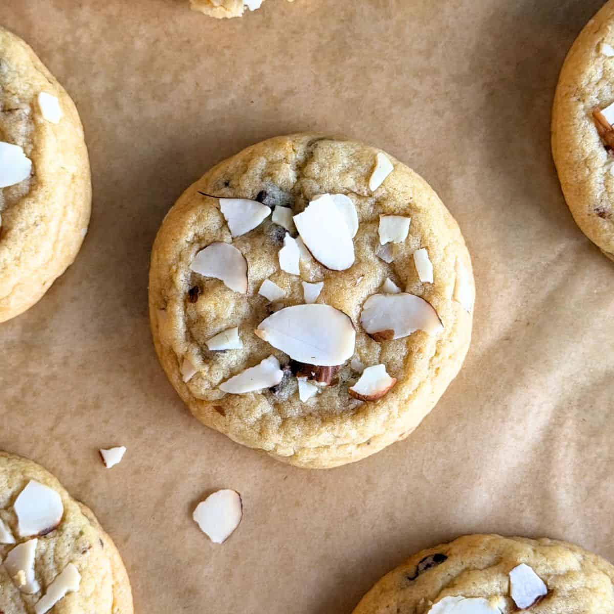 Orange almond chocolate chip cookie with slightly tan edges.