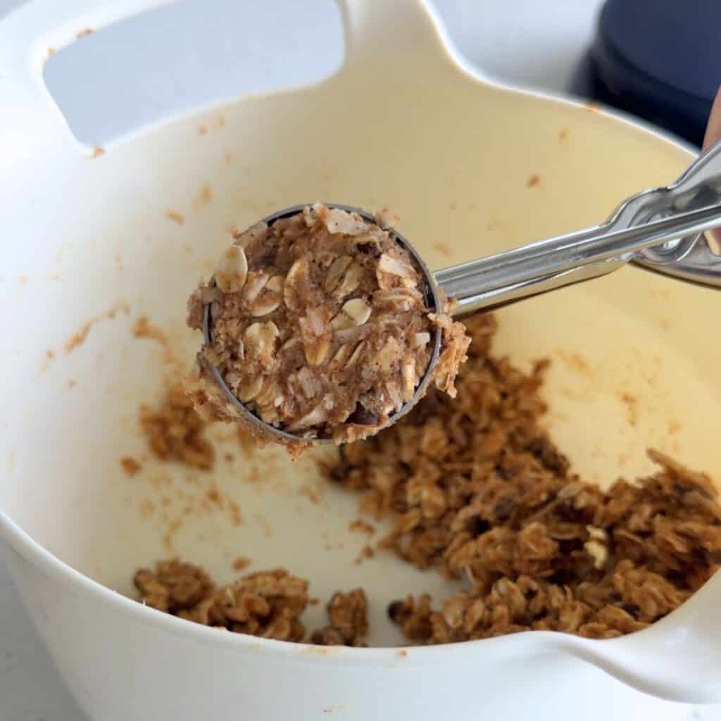 Scooping energy bite mixture.