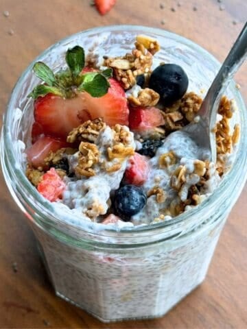 High fiber and protein chia pudding in a jar with a spoon.