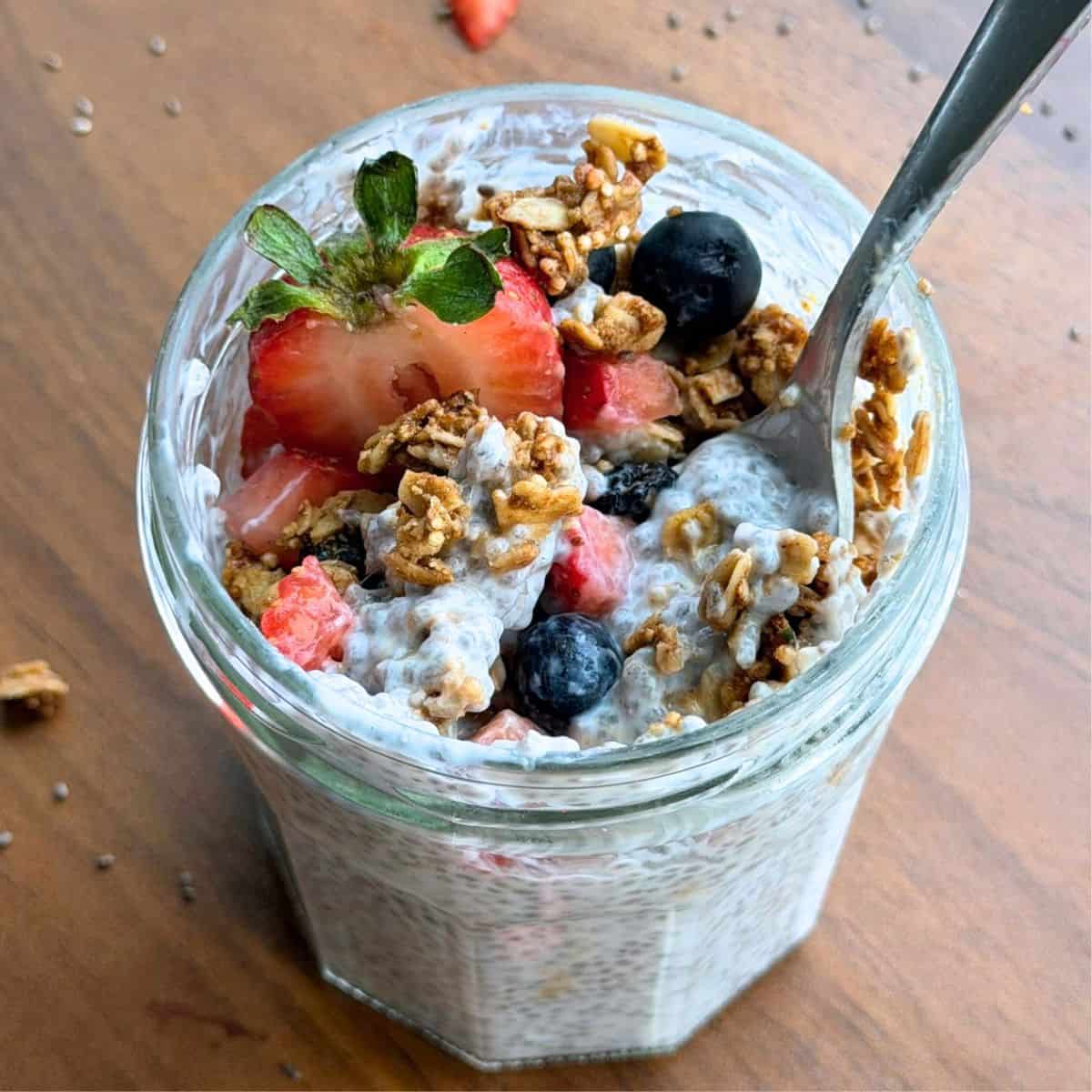 High fiber and protein chia pudding in a jar with a spoon.