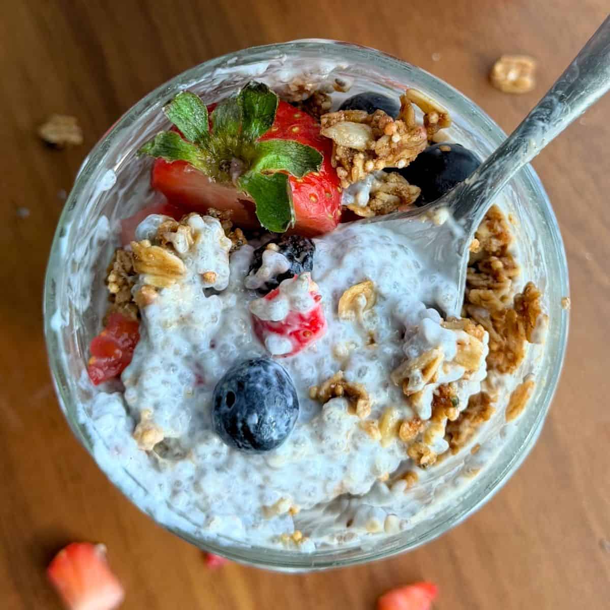 Chia seed pudding in a jar with granola and fresh fruit.